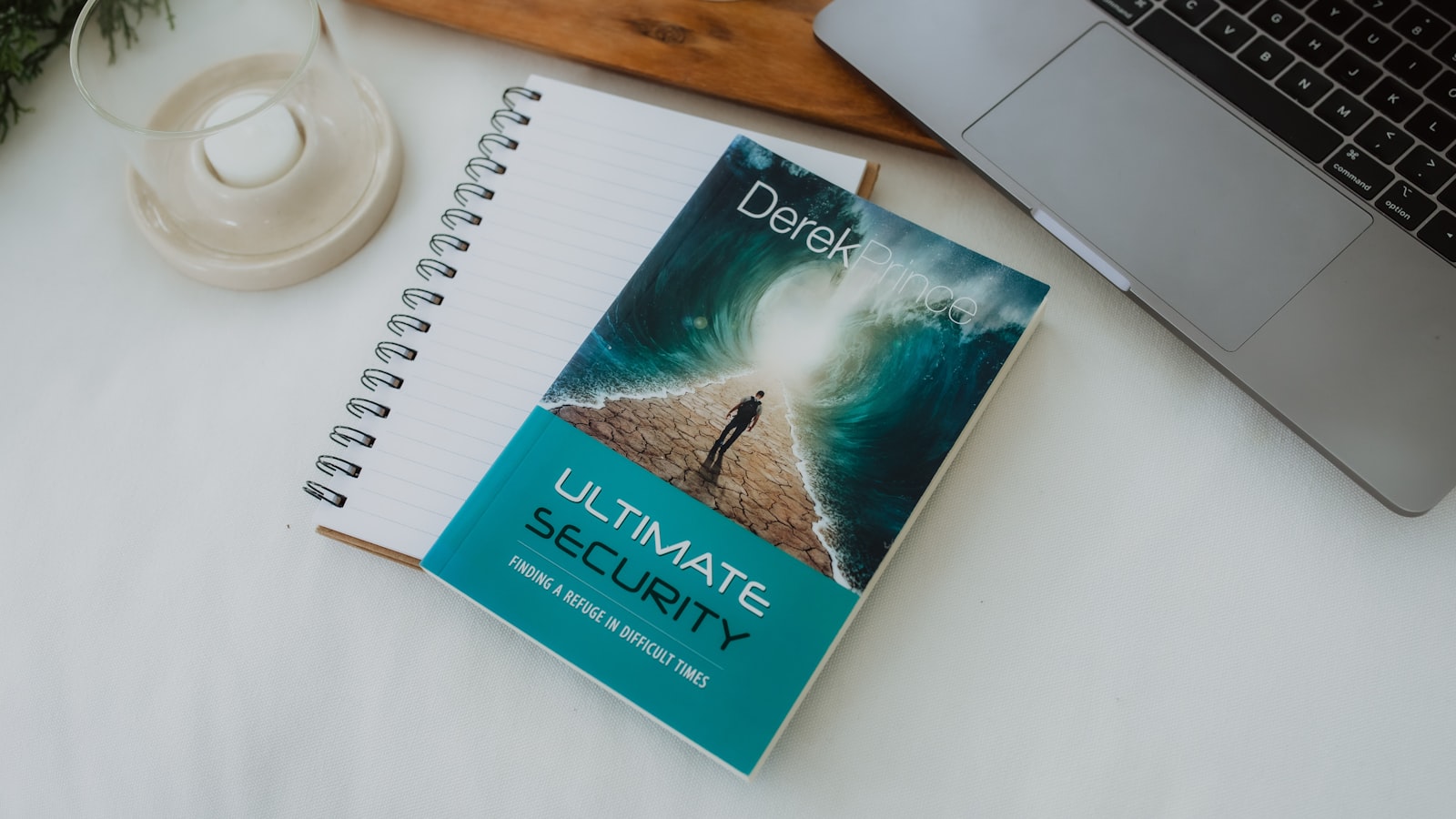 A student seated at a cluttered desk, laptop open, handwritten notes covered in crossed-out phrases, with a coffee cup casting a long shadow.