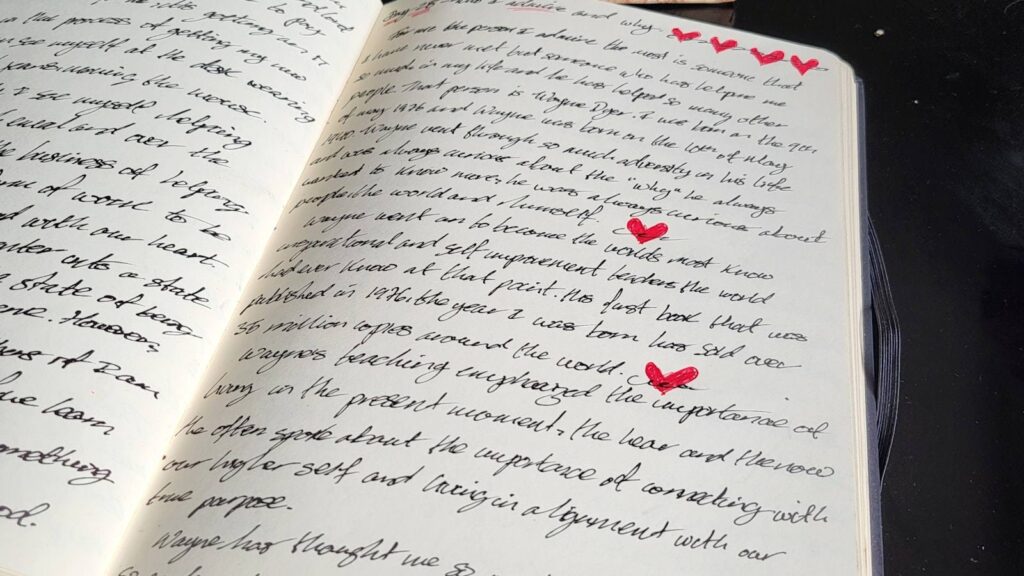 A printed manuscript marked up with marginal notes and numbered paragraph summaries on a wooden desk beside a mug and a red pen.