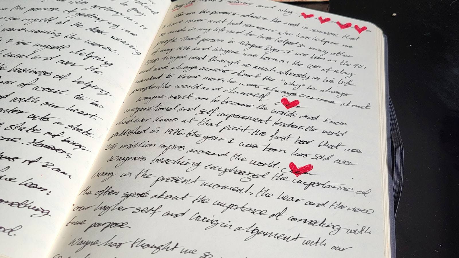 A printed manuscript marked up with marginal notes and numbered paragraph summaries on a wooden desk beside a mug and a red pen.